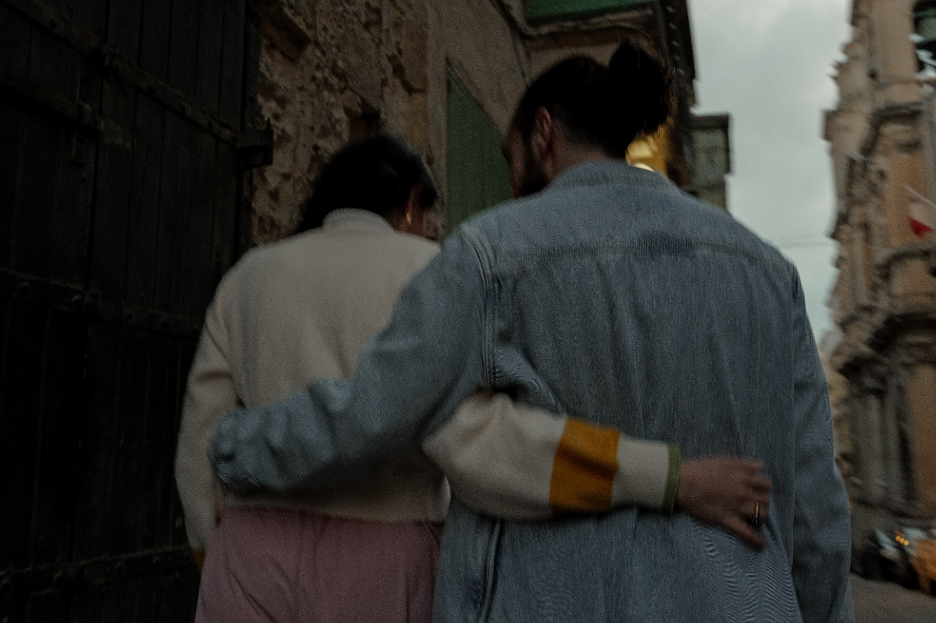 Sarah and Keith kissing while wearing headphones